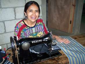 Maria Teresa sews a yoga mat bag.