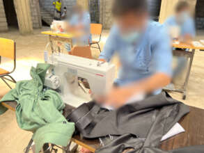 A young person hard at work on a sewing machine