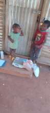 Children about to be weighed and receiving food