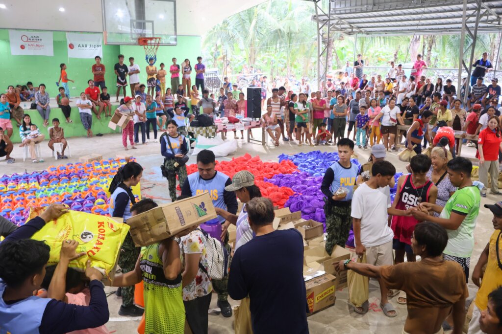 People gather at the distribution site