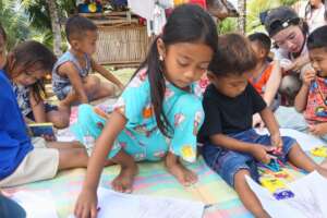 Precious (center) drawing a volcano.