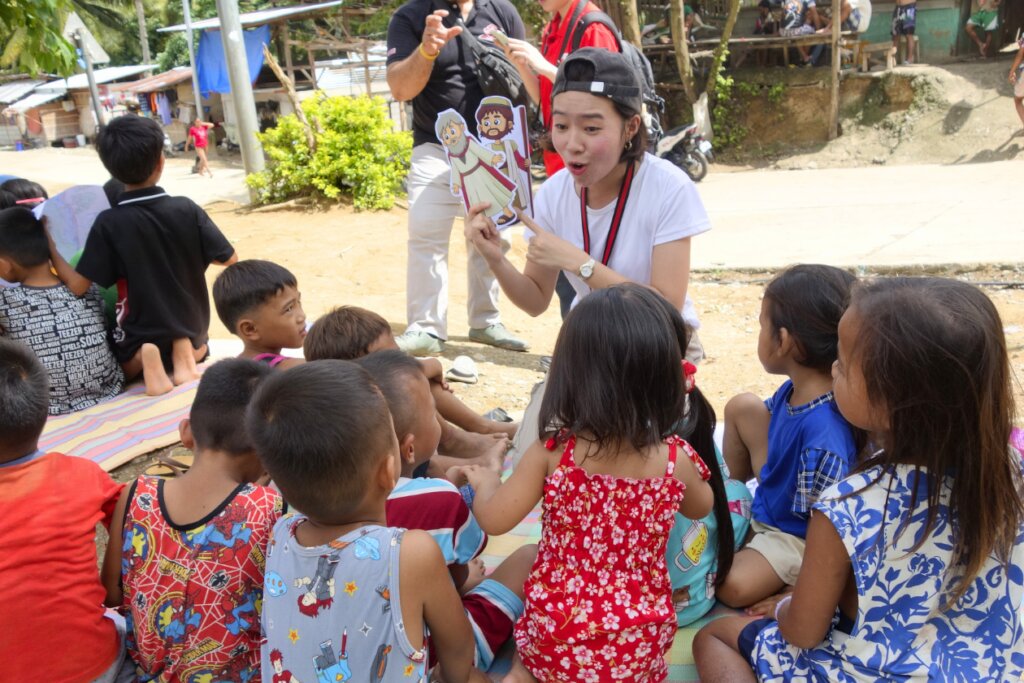 Nithy sharing a story with the children.