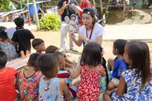 Nithy sharing a story with the children.