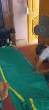 Tribal people stitching together mahua nets