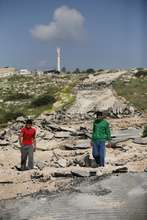 Youth standing on demolished road to Aqaba
