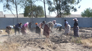 Zimkids Caregivers tilling the garden
