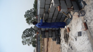 Foster, 18, laying block for the Resource Center