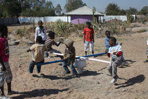 Zimkids playing on Merry-go-round