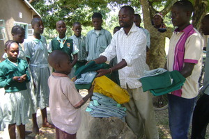 Vincent  issuing  school unforms to the kids