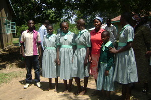 project mobilizer posing with kids in new uniform