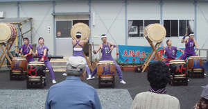 A Taiko drum team performs for evacuees.