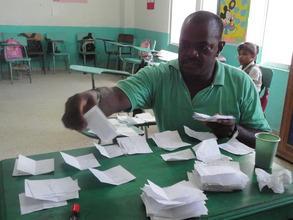 One of the teachers counts the votes
