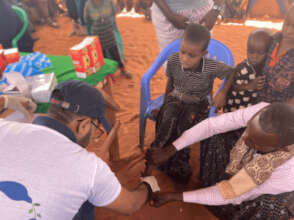 A child unable to walk due to severe malnutrition