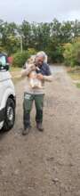 Ovidiu carries a dog to the shuttle