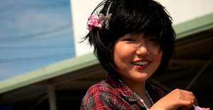 Smiling girl displaced by Japanese tsunami