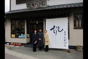 A woman outside her redone kimono shop