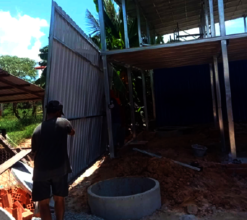 Local trades build the walls to Mrs. T's home.