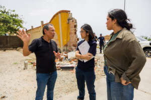 Peace Winds staff consult with local partner
