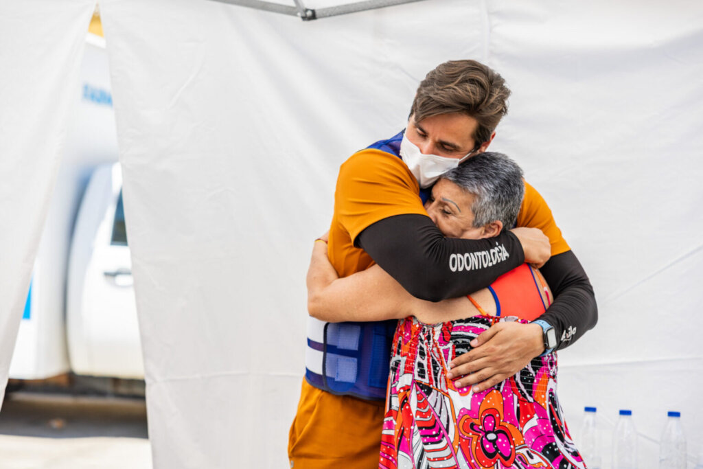 Interpreter hugs a patient