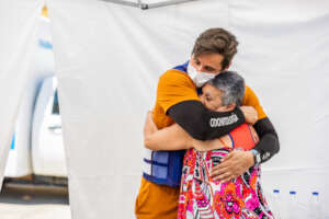 Interpreter hugs a patient