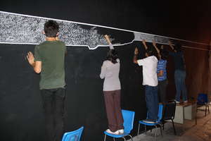 Students working in mural "Between Oppositions"