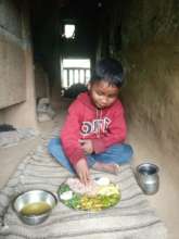 A child having greens and mushrooms in Bajura