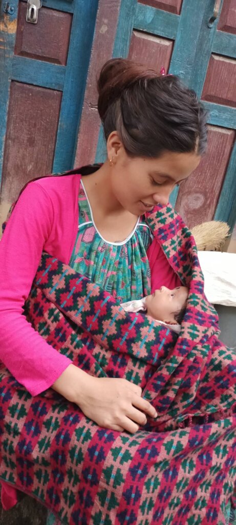 A mother and baby met for postnatal care at home.