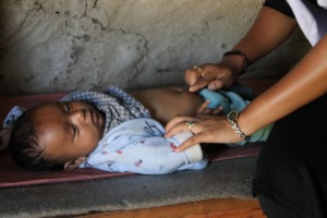 An examination of infant at PHASE Supported Clinic