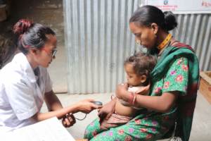 A PHASE Nepal ANM examining a baby