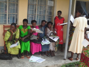 Woman at health center with ONP education posters.