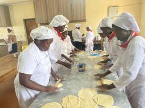 Cooking trainees making chapatis