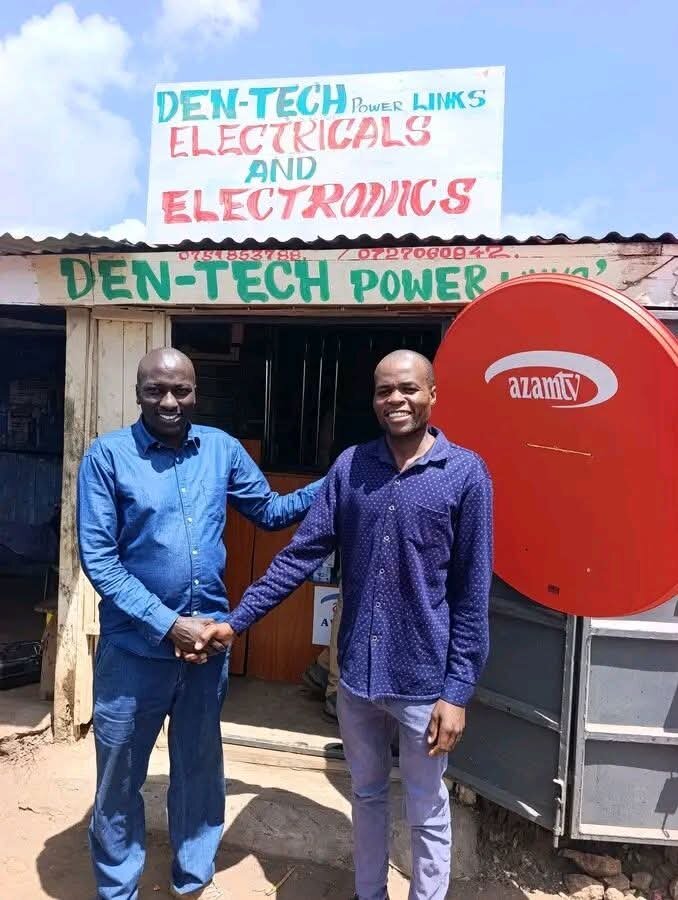 Mr Denis K. (Right) in front of his shop
