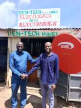 Mr Denis K. (Right) in front of his shop