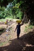 Community member carrying water.