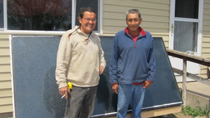 Joe Yellow Hawk (right) with his new solar heater