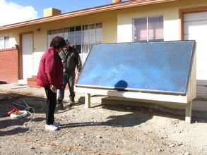 Eva Stokely inspects her new solar air heater