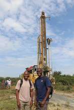 Ben (left) and Charles Odipo with the drill rig