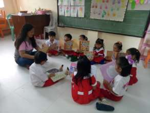 Children gather around for a little book-reading