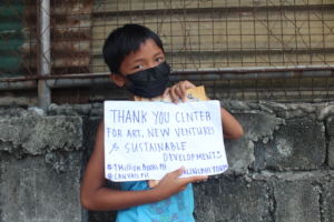 Thank you signs and smiles behind masks.