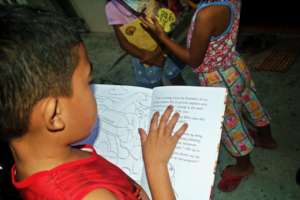 Boy dives into the pages of environmental book.