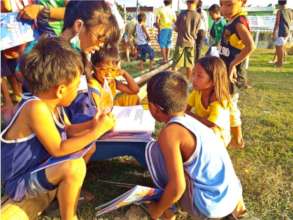 Kids gather round a volunteer for story-telling.