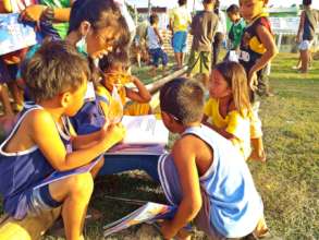 At an evacuation center, reading books together