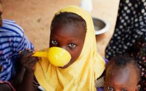 A young girl shares nunu drink with her siblings
