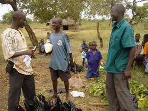 Orphan receives food donation from CCI-Uganda