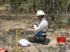 exposing a live landmine to be destroyed