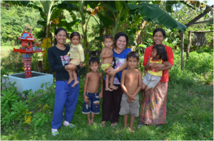 Families stand on HALO cleared ground.