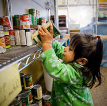 Child picking out food at a Portland food pantry
