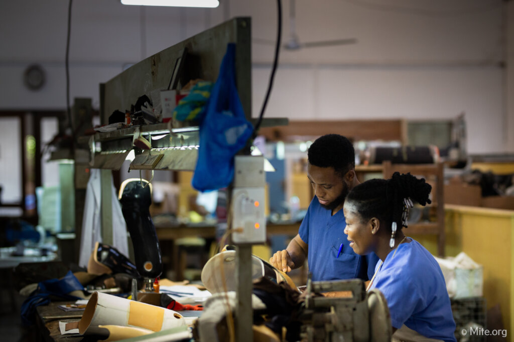 Prosthetists work on legs donated by STAND