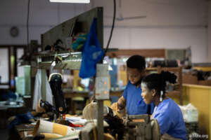 Prosthetists work on legs donated by STAND