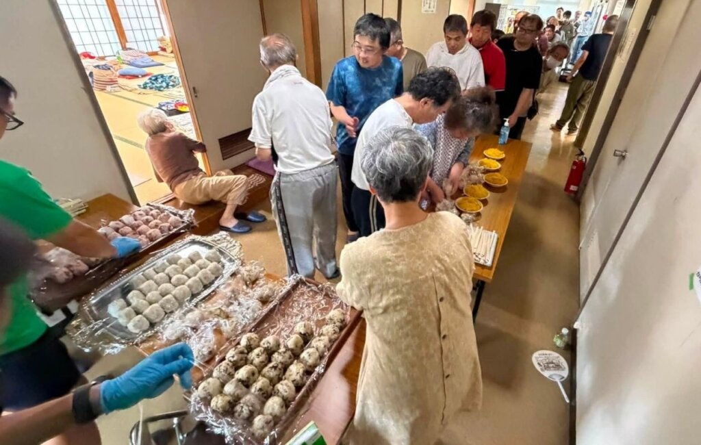 Evacuees lining up for a meal at the shelter